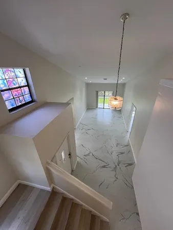 a view of an empty room with windows