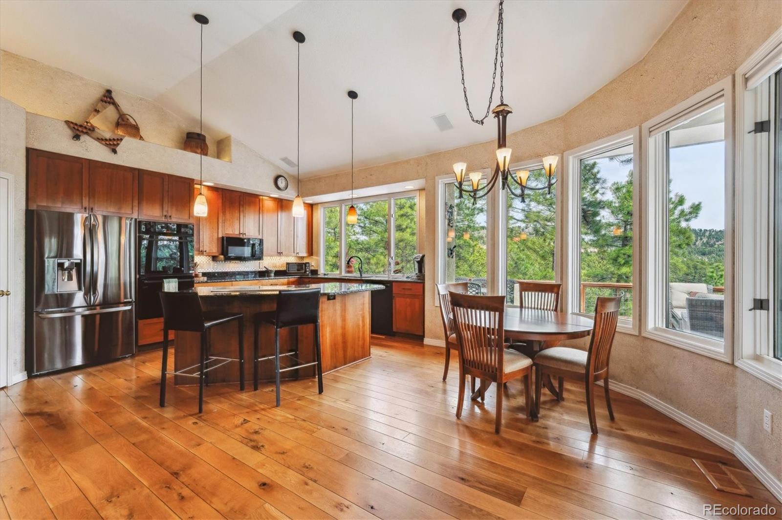 1784 Prima Lane Evergreen, CO 80439 - Photo 12 of 37 a view of a dining room and livingroom with furniture large window a chandelier