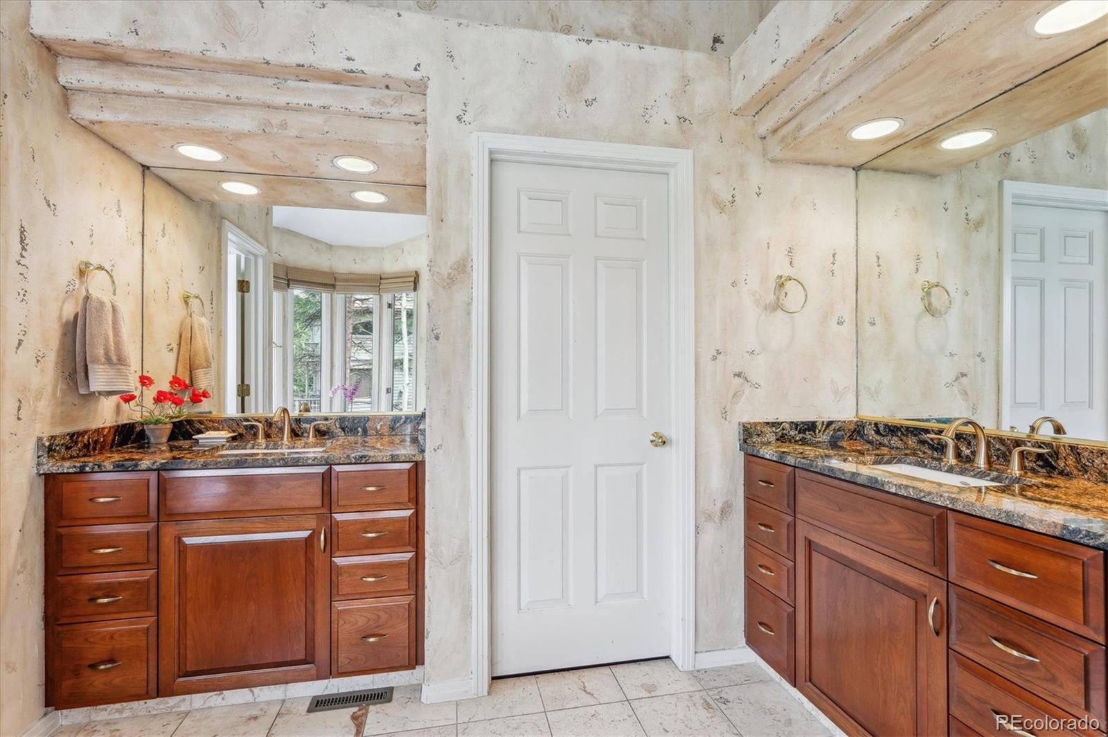 1784 Prima Lane Evergreen, CO 80439 - Photo 24 of 37 a bathroom with a double vanity sink and mirror