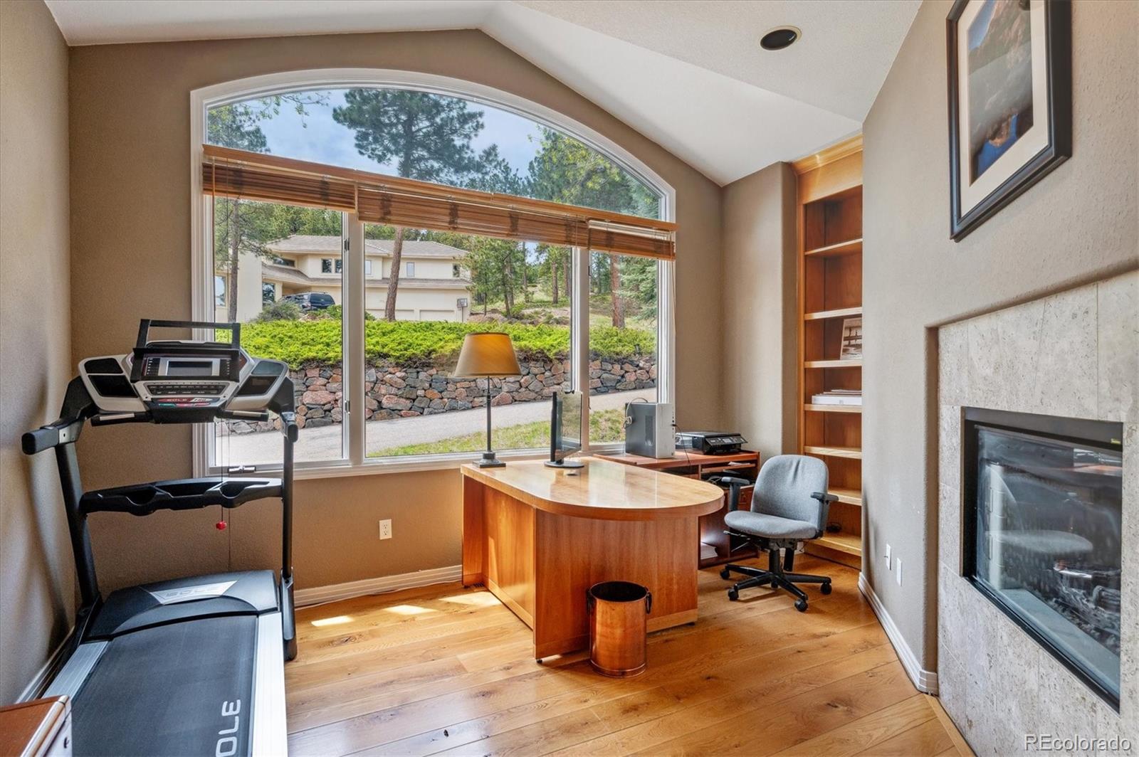 1784 Prima Lane Evergreen, CO 80439 - Photo 25 of 37 a living room with patio furniture and a fireplace