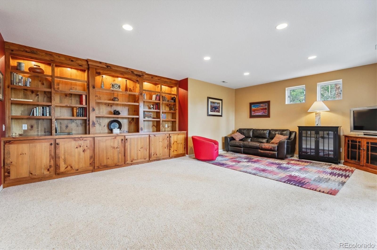 1784 Prima Lane Evergreen, CO 80439 - Photo 27 of 37 a living room with furniture pool and flat screen tv