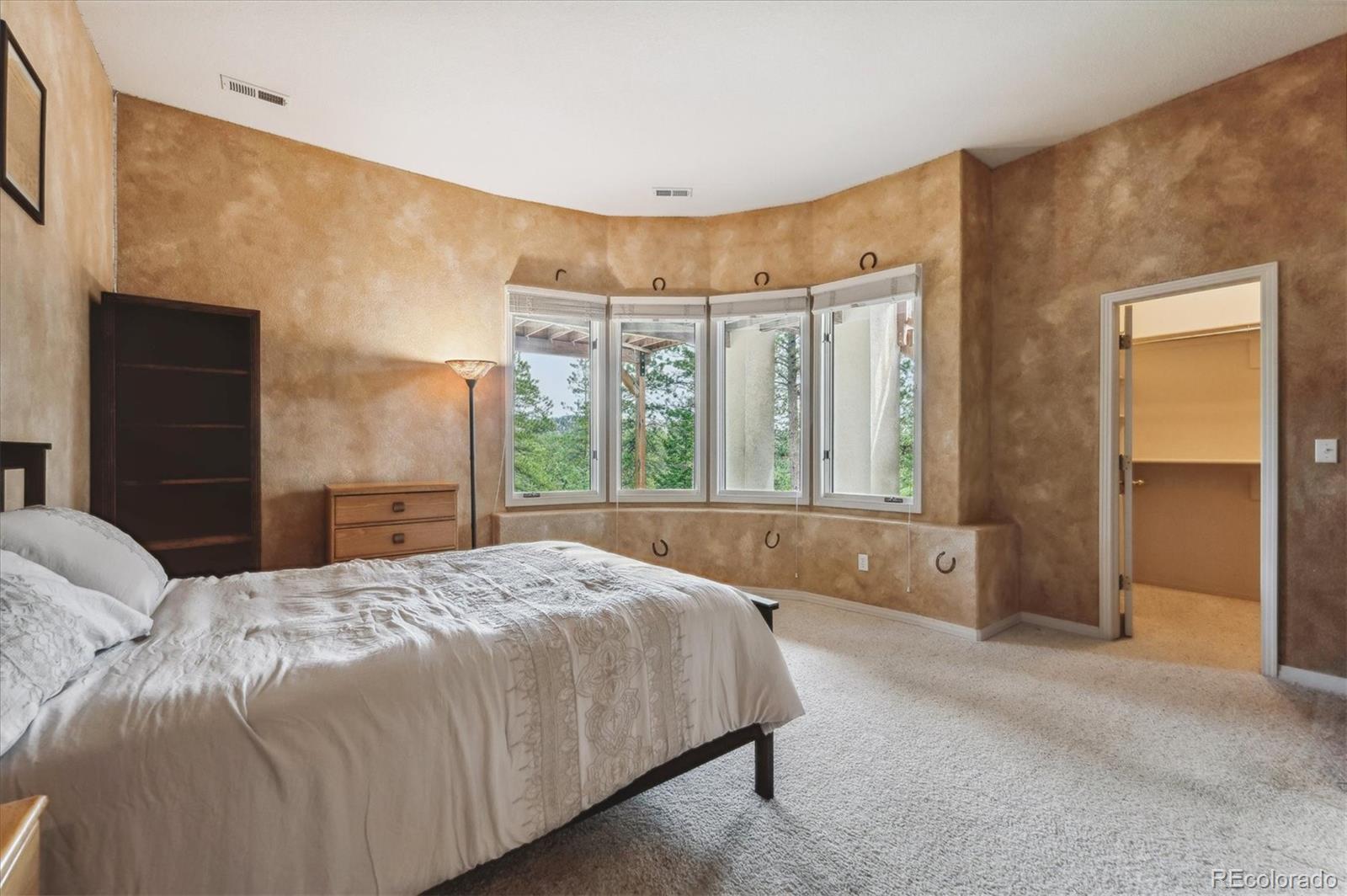 1784 Prima Lane Evergreen, CO 80439 - Photo 29 of 37 a bedroom with a bed and a large window