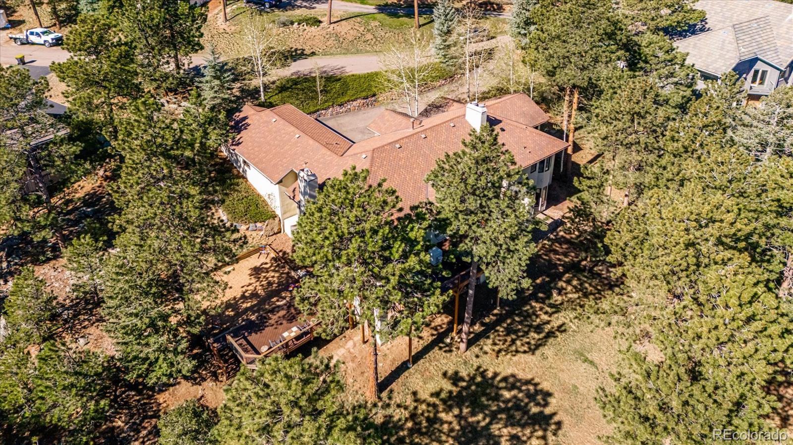 1784 Prima Lane Evergreen, CO 80439 - Photo 36 of 37 an aerial view of residential house with swimming pool and lawn chairs