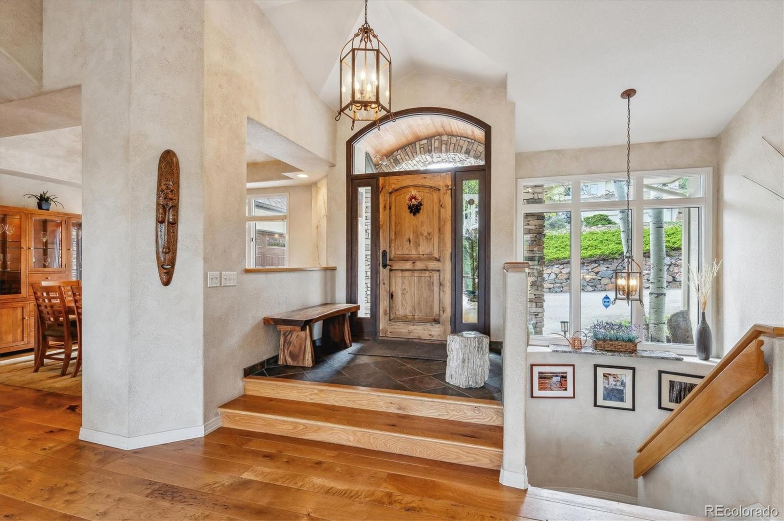 1784 Prima Lane Evergreen, CO 80439 - Photo 7 of 37 a living room with fireplace furniture and a chandelier