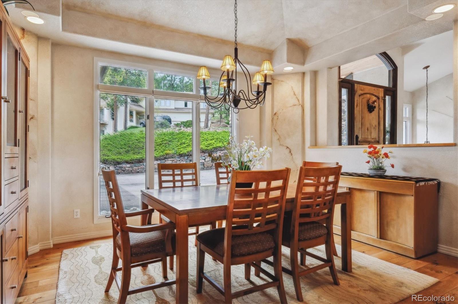 1784 Prima Lane Evergreen, CO 80439 - Photo 8 of 37 a view of a dining room and livingroom with furniture wooden floor a chandelier