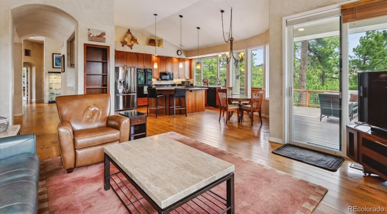 1784 Prima Lane Evergreen, CO 80439 - Photo 10 of 37 a living room with fireplace furniture and a large window