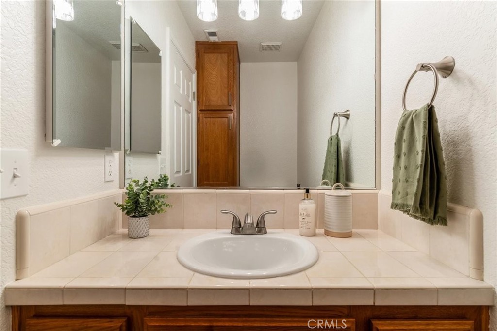 646 Shady Lane Santa Maria, CA 93455 - Photo 23 of 44 a bathroom with a sink and a mirror