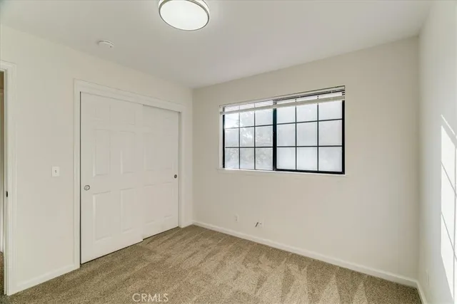 a bathroom with a sink a toilet a mirror a bathtub and shower