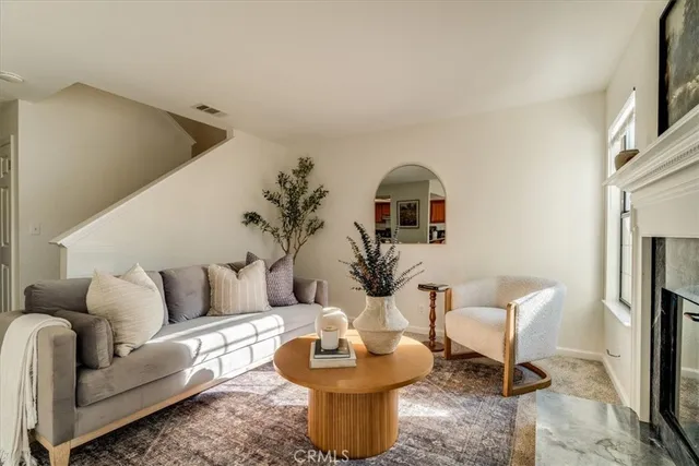a living room with furniture and a fireplace