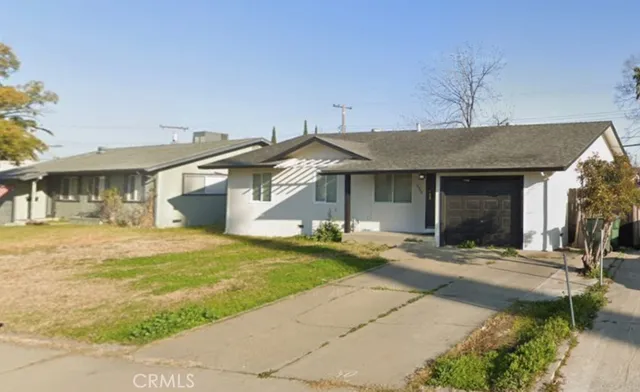 a front view of a house with a garden and patio