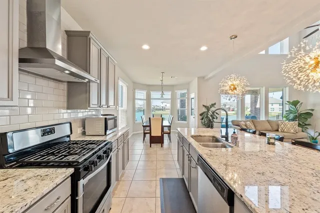 a large kitchen with stainless steel appliances granite countertop a lot of counter space