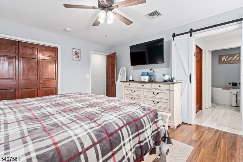 30 Lanning Road Blairstown, NJ 07825 - Photo 16 of 40 a bedroom with a bed and a flat screen tv