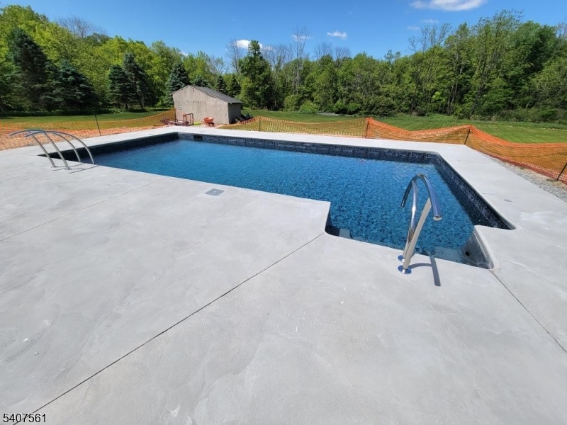 30 Lanning Road Blairstown, NJ 07825 - Photo 39 of 40 a view of swimming pool with seating area and trees in the background