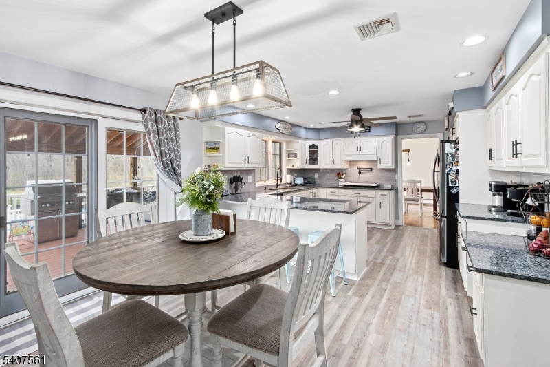 30 Lanning Road Blairstown, NJ 07825 - Photo 8 of 40 a kitchen with stainless steel appliances kitchen island granite countertop a dining table chairs and granite counter tops