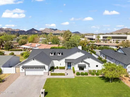 a aerial view of a house with a big yard and large trees