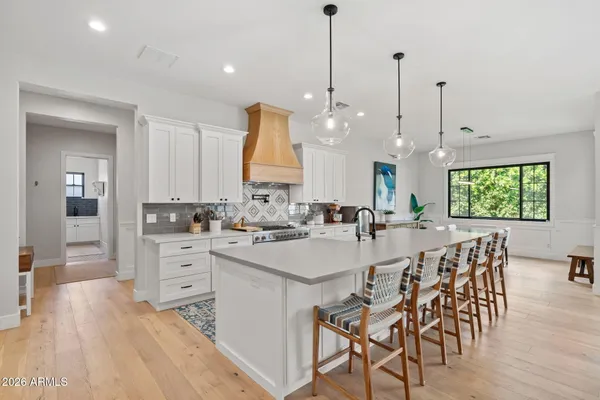 a kitchen with stainless steel appliances kitchen island a sink stove and cabinets