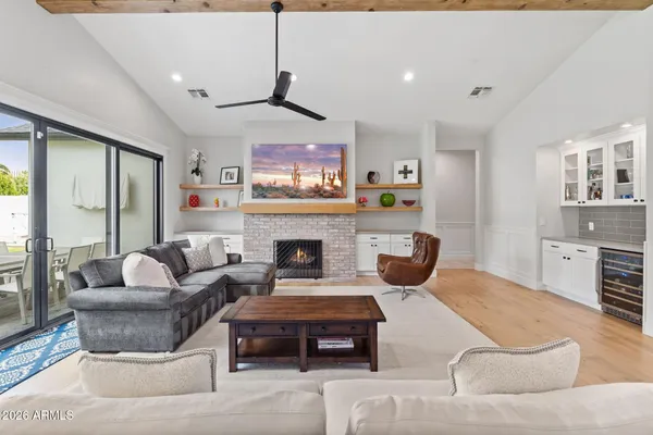 a very nice looking living room with a large window a couch and fireplace