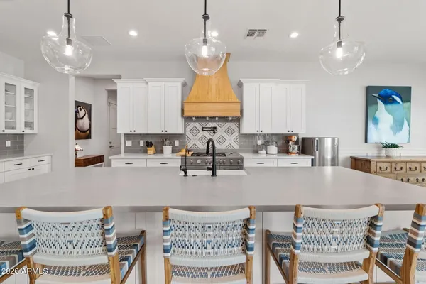 a large kitchen with a table and chairs