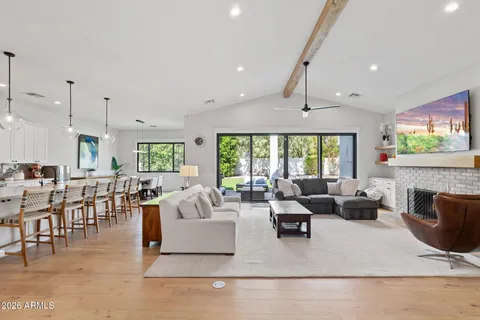 a living room with fireplace furniture and a large window