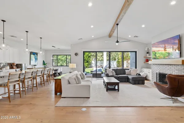 a living room with fireplace furniture and a large window