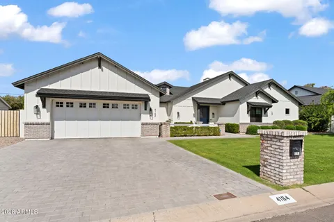 a dining room with furniture and large windows