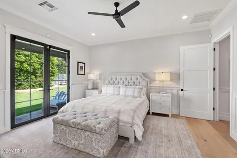 a bedroom with a bed painting and wooden floor