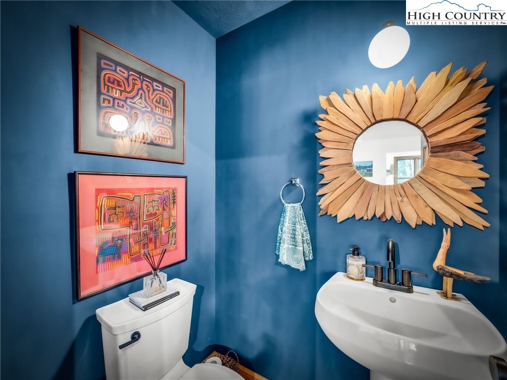 165 All Hallows Road Boone, NC 28607 - Photo 20 of 50 a bathroom with a sink mirror and vanity