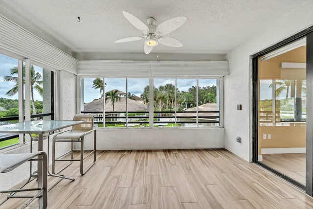 a view of a hallway to a livingroom with furniture and wooden floor
