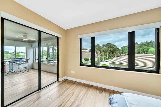 a view of a hallway with wooden floor and closet area