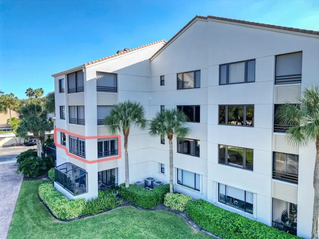 a living room with furniture floor to ceiling window and a flat screen tv