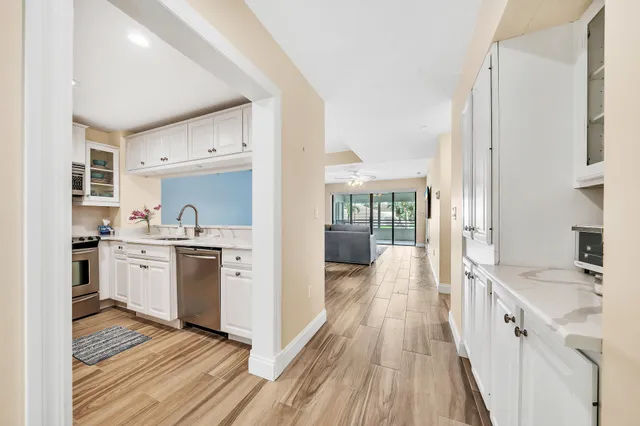 a view of a dining room with furniture a rug and wooden floor