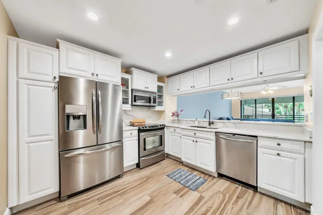 a living room with furniture a ceiling fan and a rug