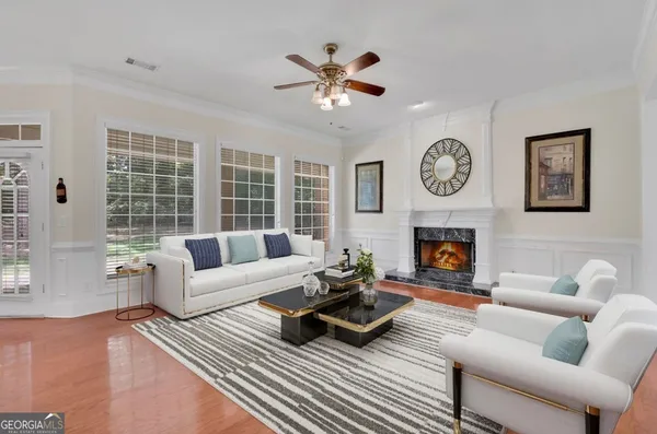 a living room with furniture a clock and a fireplace