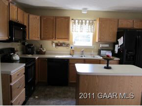 2544 North River Road Bridgewater, VA 22812 - Photo 7 of 20 a kitchen with kitchen island granite countertop a sink window and cabinets