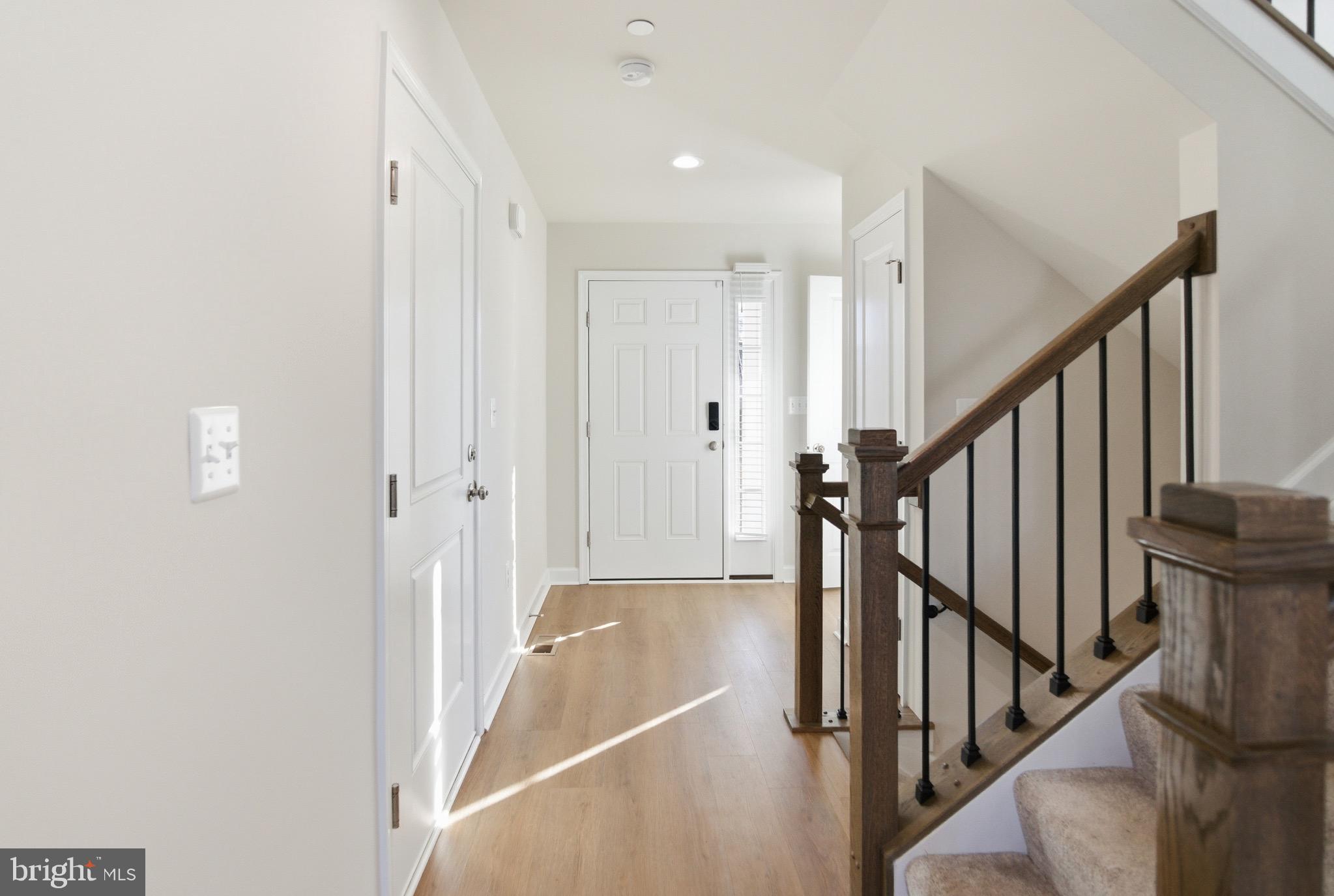 504 Cleveland Road Linthicum Heights, MD 21090 - Photo 11 of 54 a view of a hallway with wooden floor and staircase