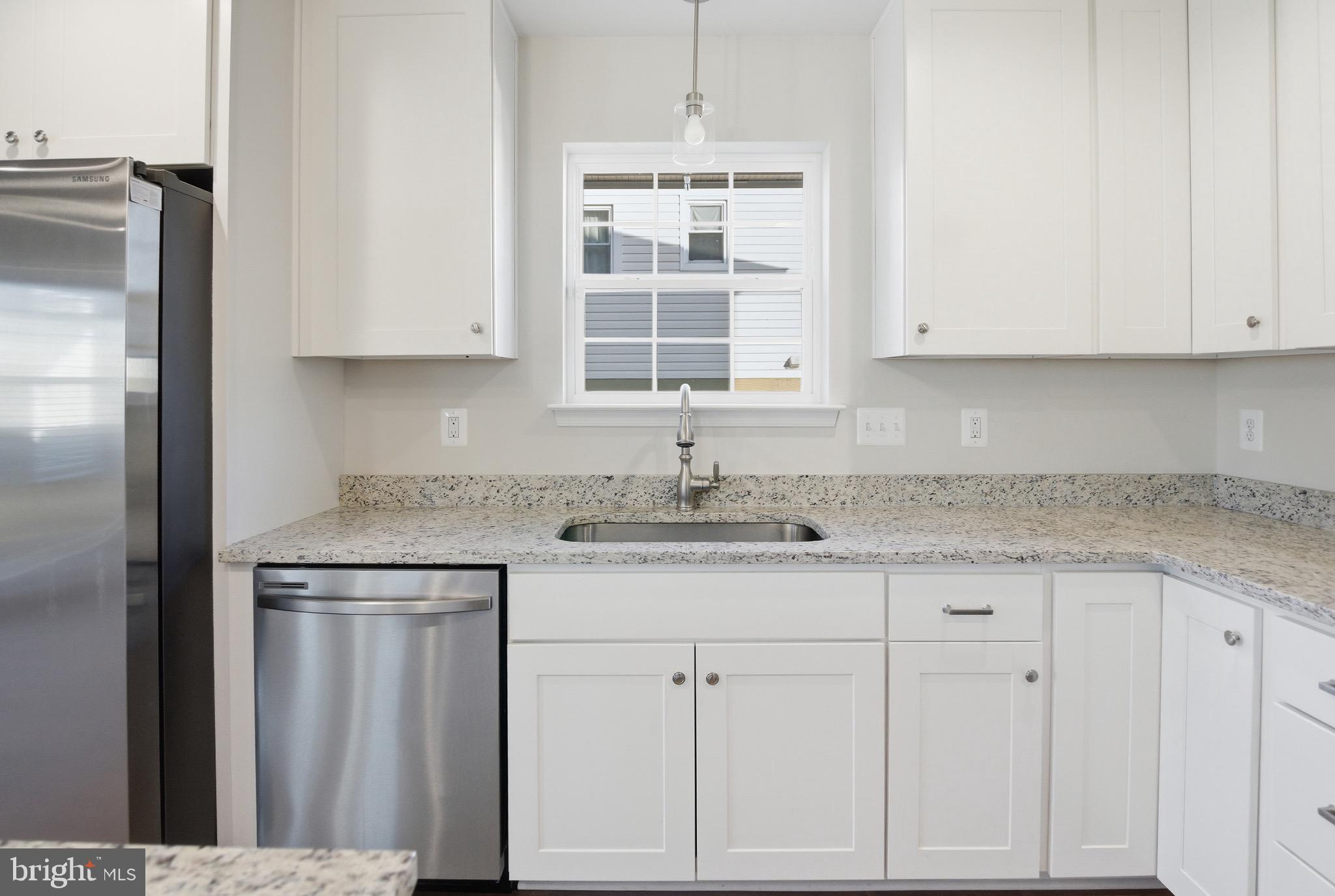 504 Cleveland Road Linthicum Heights, MD 21090 - Photo 17 of 54 a kitchen with granite countertop white cabinets and sink