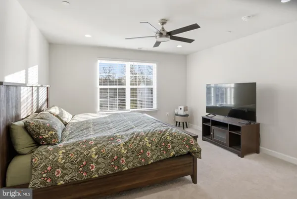 a bedroom with a bed couch and window