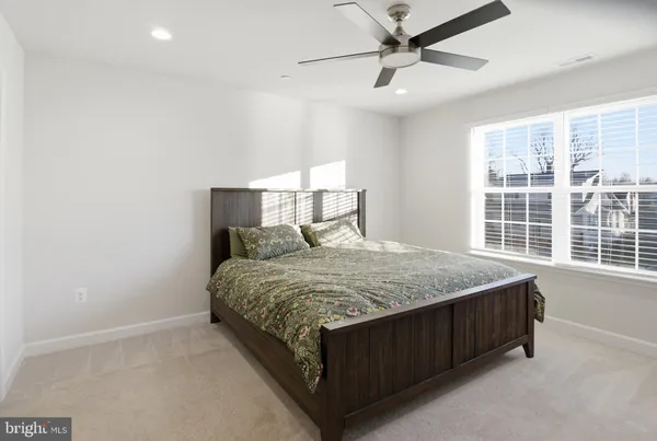 a bed sitting in a room next to a window