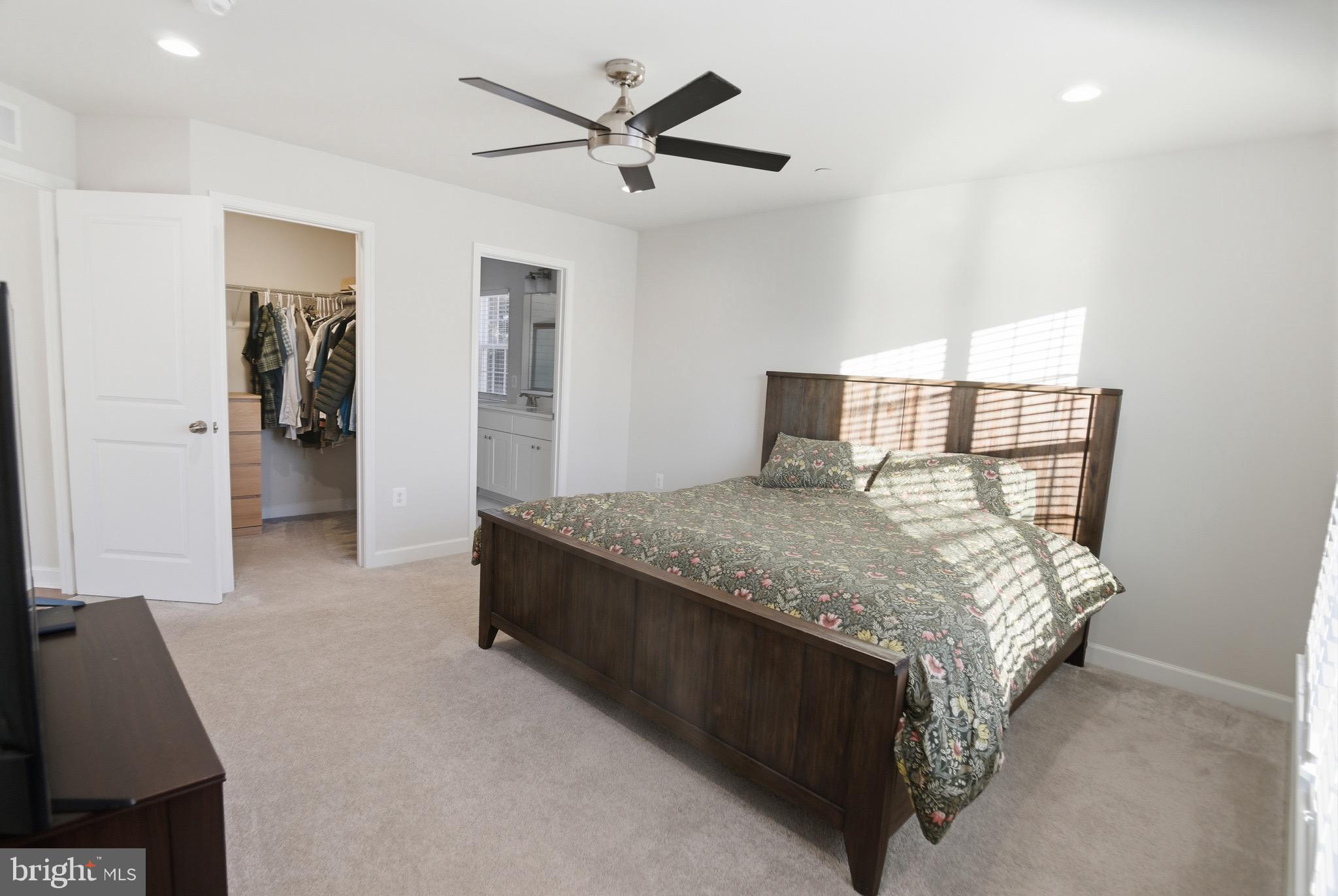 504 Cleveland Road Linthicum Heights, MD 21090 - Photo 23 of 54 a spacious bedroom with a bed and a chandelier