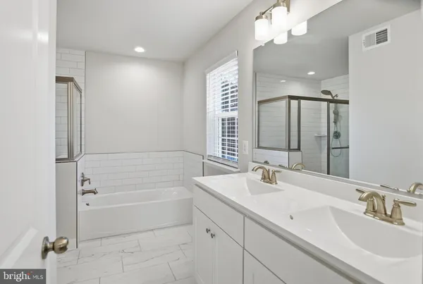 a bathroom with a tub sink and mirror