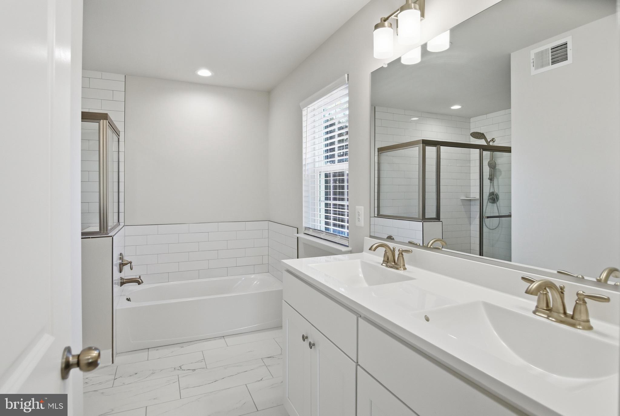 504 Cleveland Road Linthicum Heights, MD 21090 - Photo 26 of 54 a bathroom with a tub sink and mirror