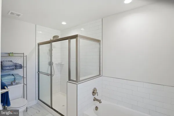 a bathroom with a shower and a toilet