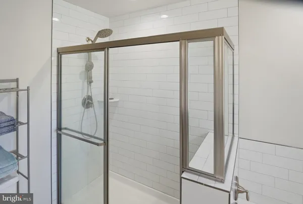 a bathroom with a shower and a glass door