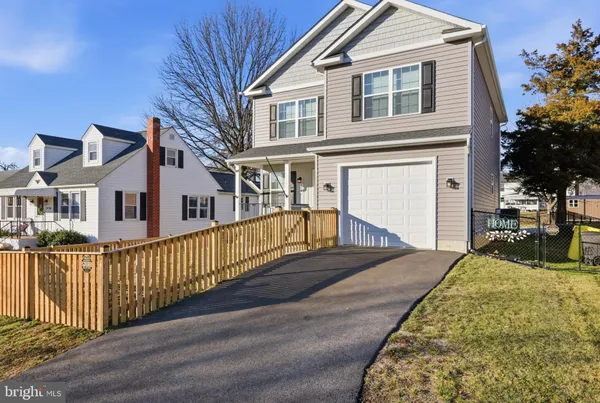 a view of a house with wooden fence