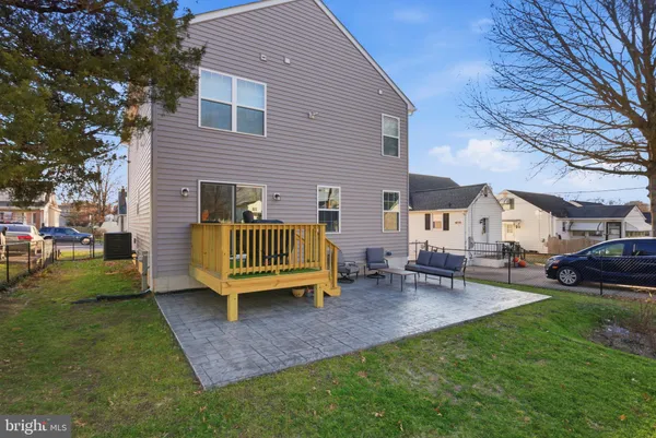a view of a house with a backyard and sitting area