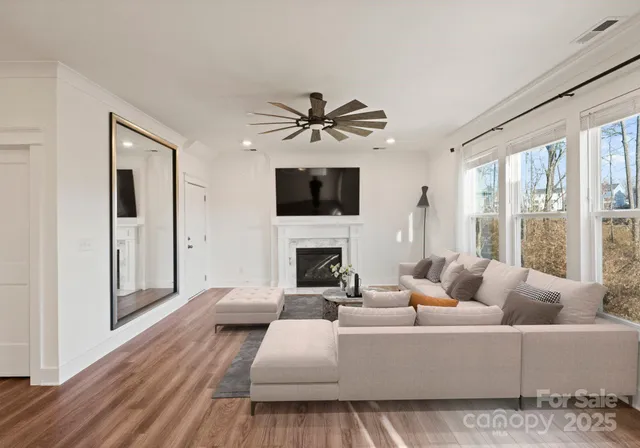a living room with furniture a fireplace and a flat screen tv