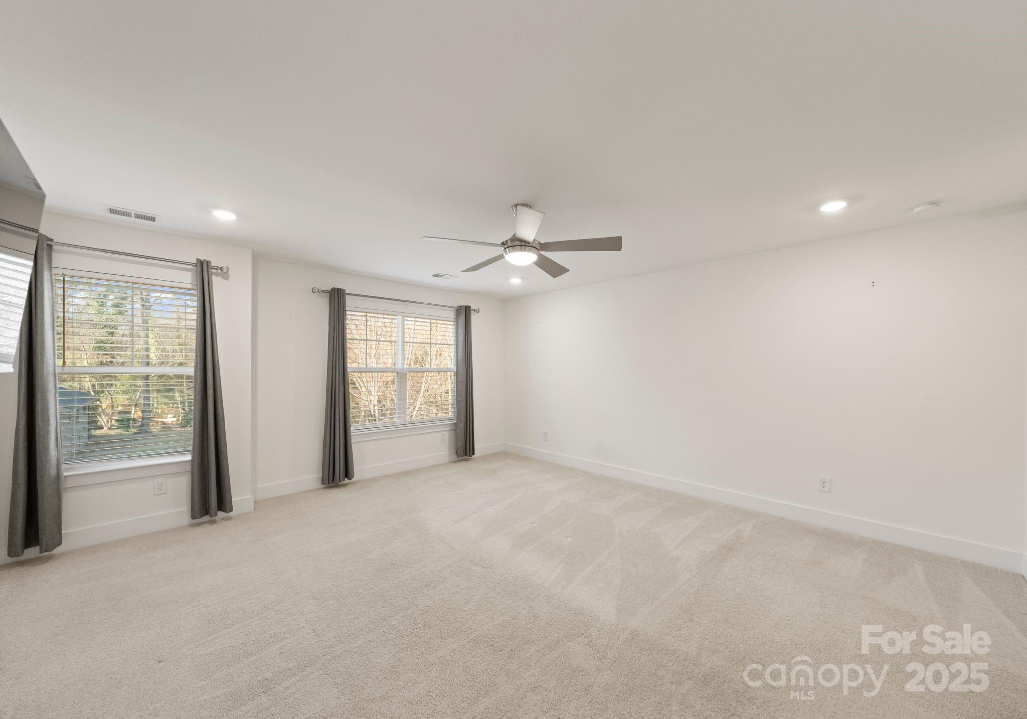 619-r L R L Stowe Road Belmont, NC 28012 - Photo 17 of 33 an empty room with windows and ceiling fan