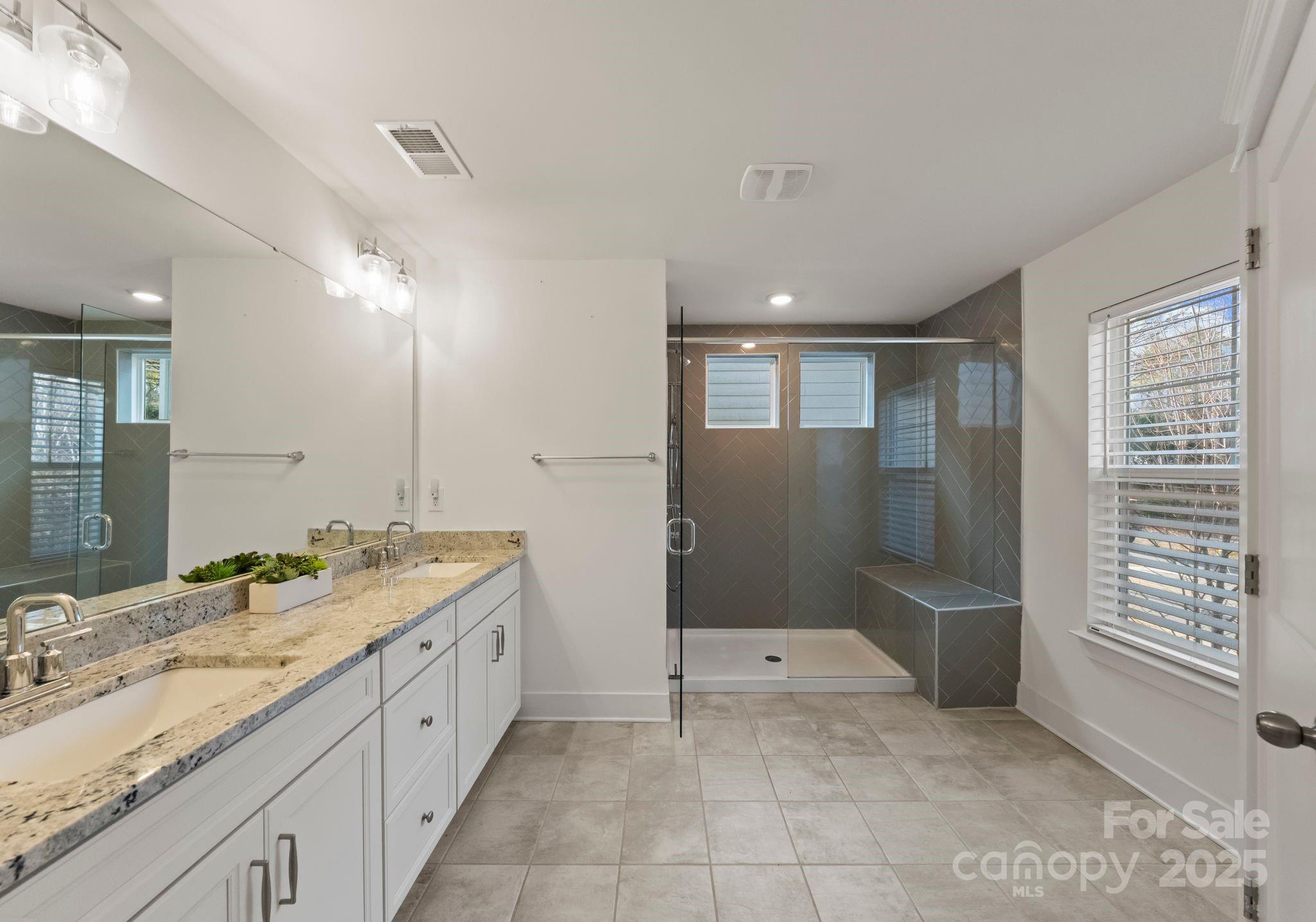 619-r L R L Stowe Road Belmont, NC 28012 - Photo 19 of 33 a spacious bathroom with a granite countertop sink a mirror and a shower