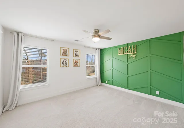a view of a room with window and a ceiling fan