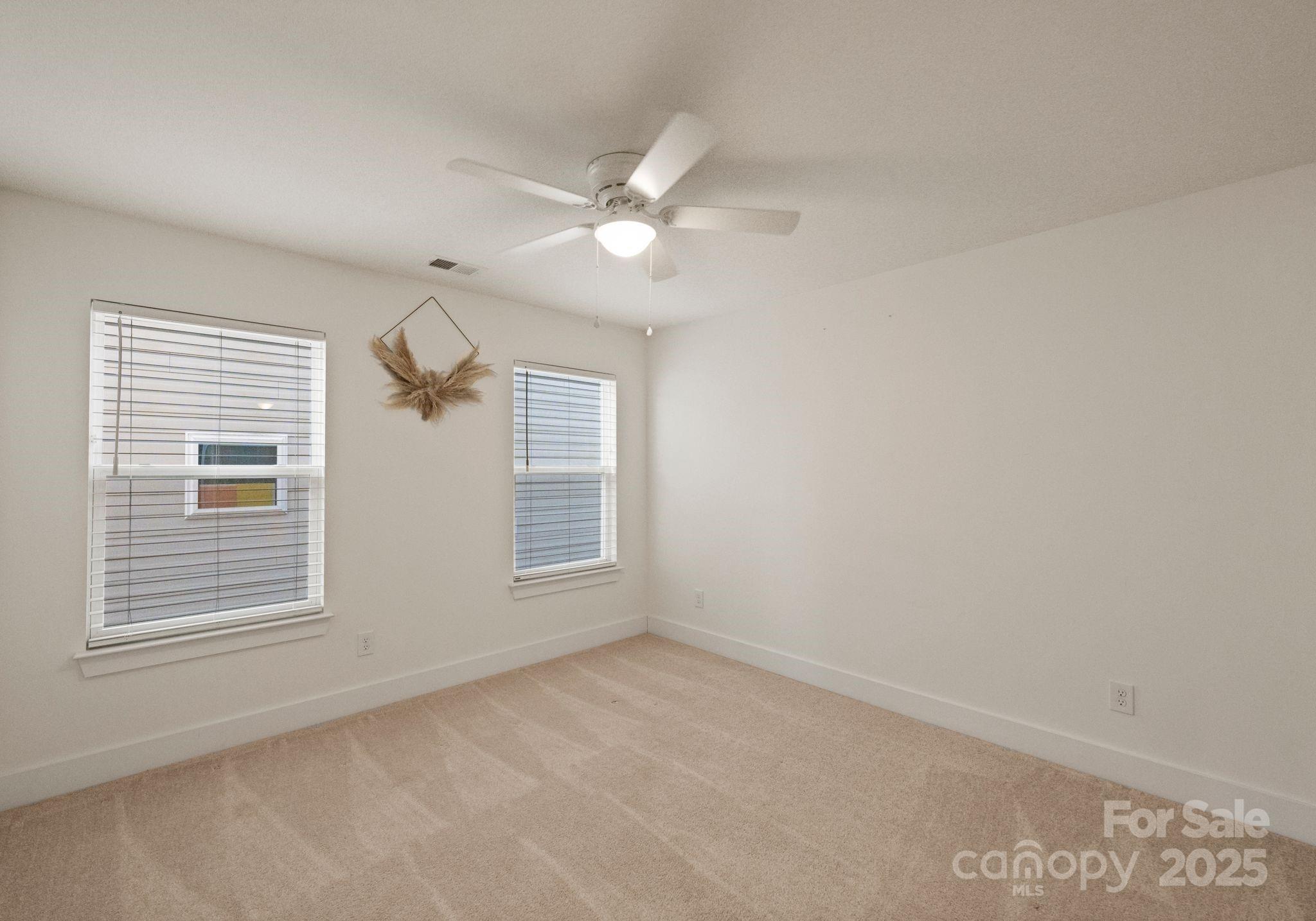 619-r L R L Stowe Road Belmont, NC 28012 - Photo 23 of 33 an empty room with chandelier fan and windows